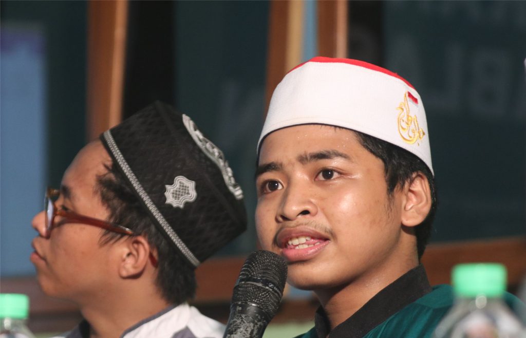 Miromly Attakriny sedang mempresentasikan artikelnya tentang toleransi antar umat beragama.
